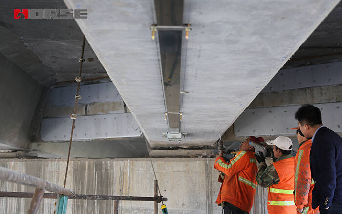 Prestressed carbon fiber laminate reinforced concrete bridge with damage