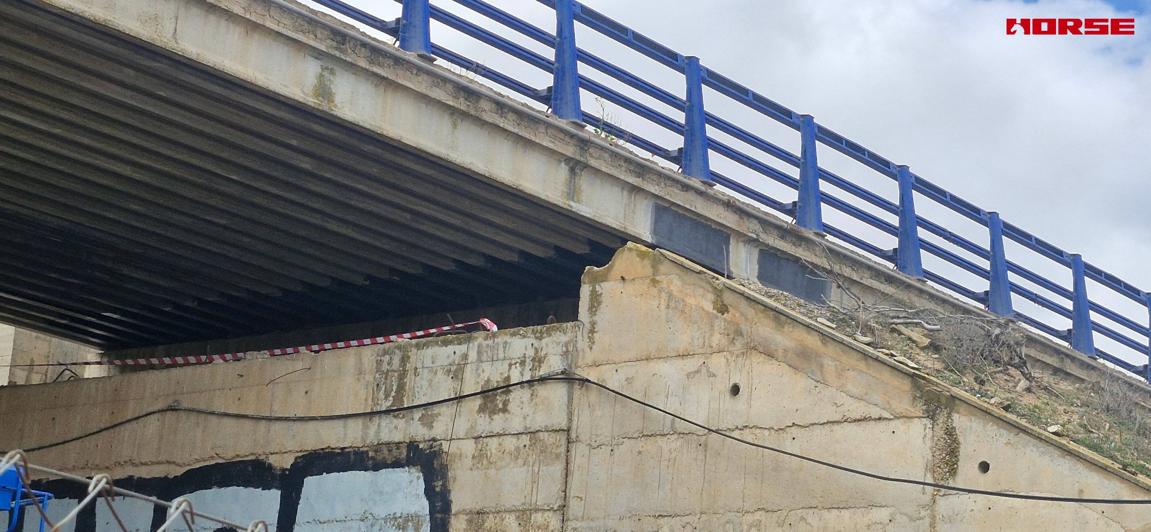 Strengthening of a Prestressed Concrete Multi-Girder Bridge with CFRP Laminate and U-warp